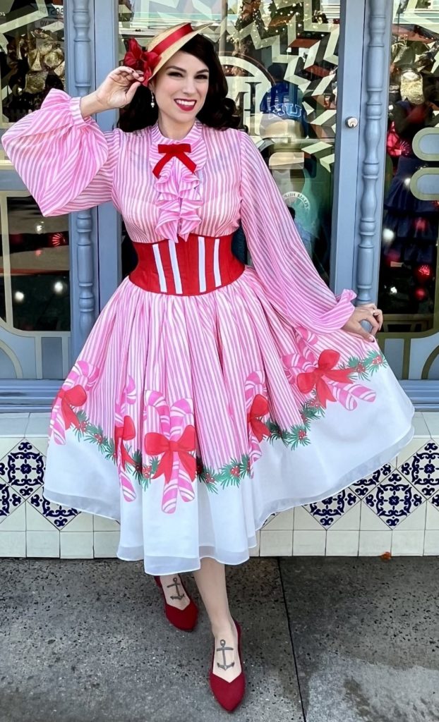 Mary Poppins inspired candy cane print holiday outfit with the Patsy Blouse, Waspie Corset Belt, and fabric from Charm Patterns.