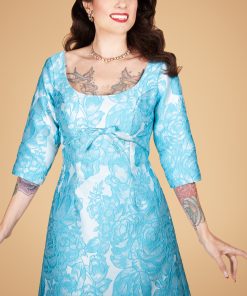Gertie wearing a blue brocade American Beauty Dress.