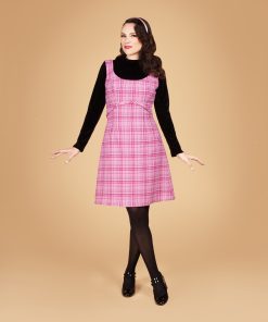 Gertie wearing a pink plaid wool American Beauty Dress, styled as a jumper over a black turtleneck with black tights.