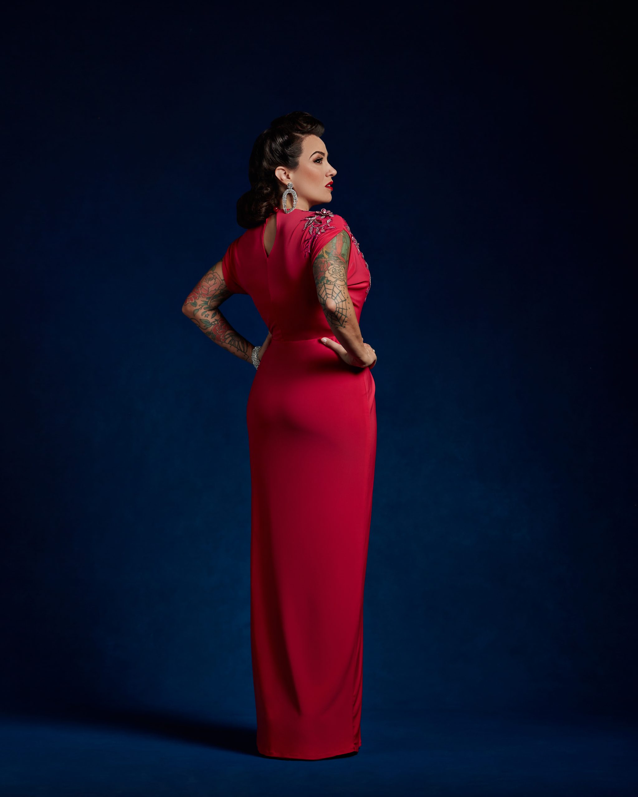 Gertie wearing a fuschia Siren Bodice with a Side Drape Skirt.